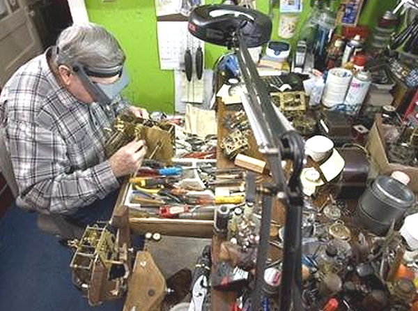 A clock repair expert specializes in grandfather clock